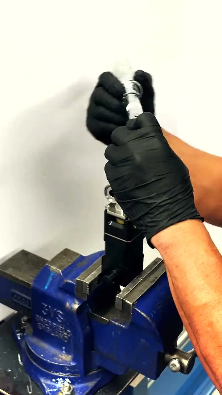 A diaphragm valve being assembled by hand in a bench vise, bonnet fitted to the body